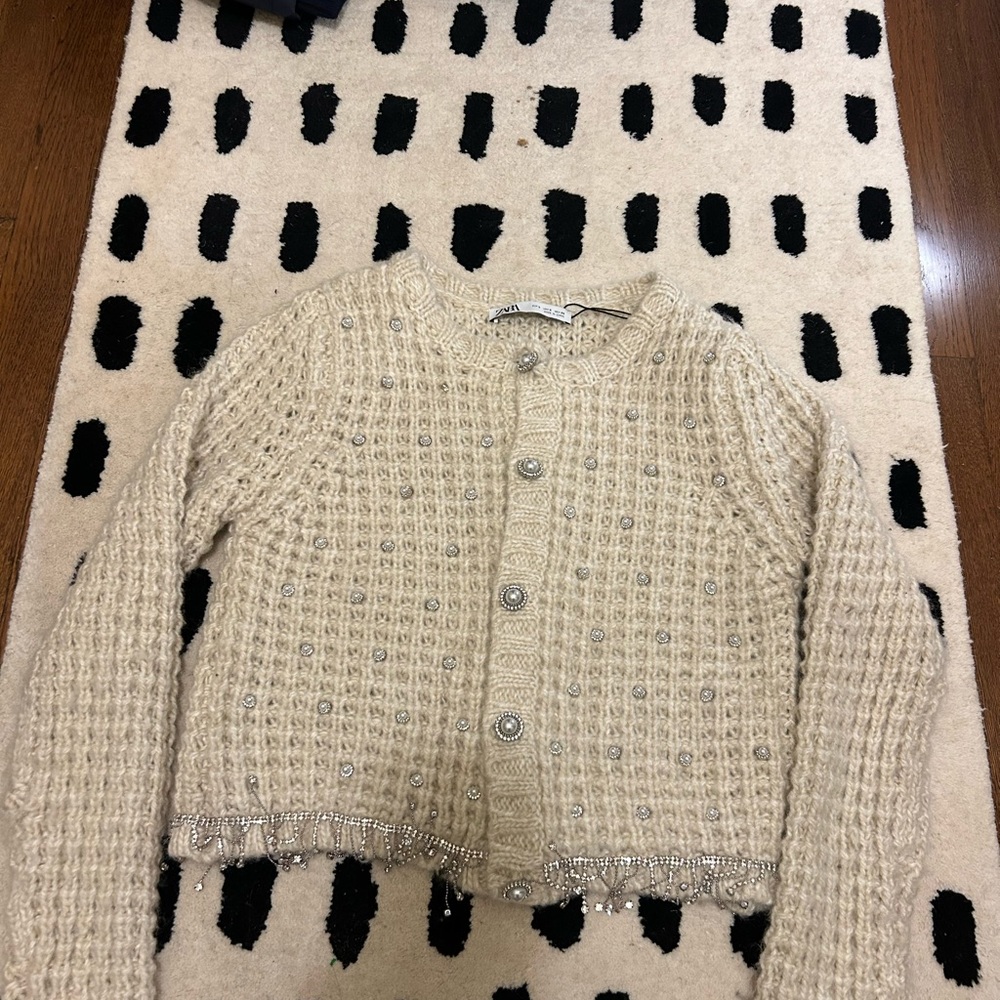 Cream sweater with pearl embellishment and rhinestone fringe
